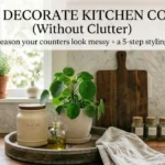 A beautifully styled, bright kitchen counter demonstrating how to decorate kitchen counters without clutter using a wooden tray, natural plant and glass jars.