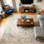 L-shaped sectional sofa on a 9x12 area rug with front legs on rug placement in a neutral living room